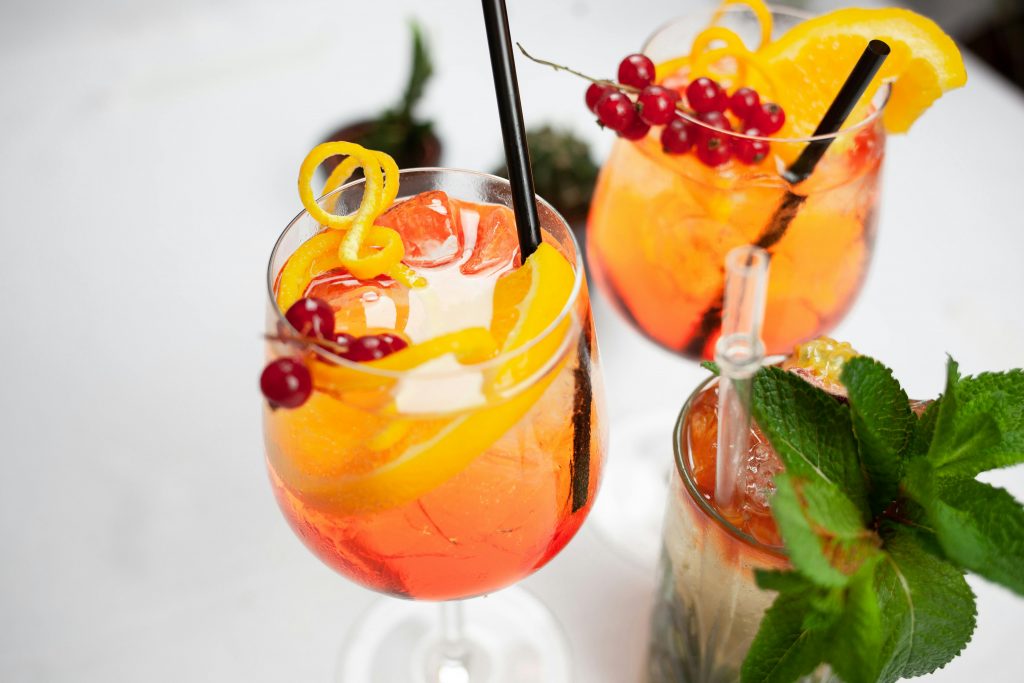 Vibrant citrus and berry mocktails with orange slices, mint, and a festive garnish.
